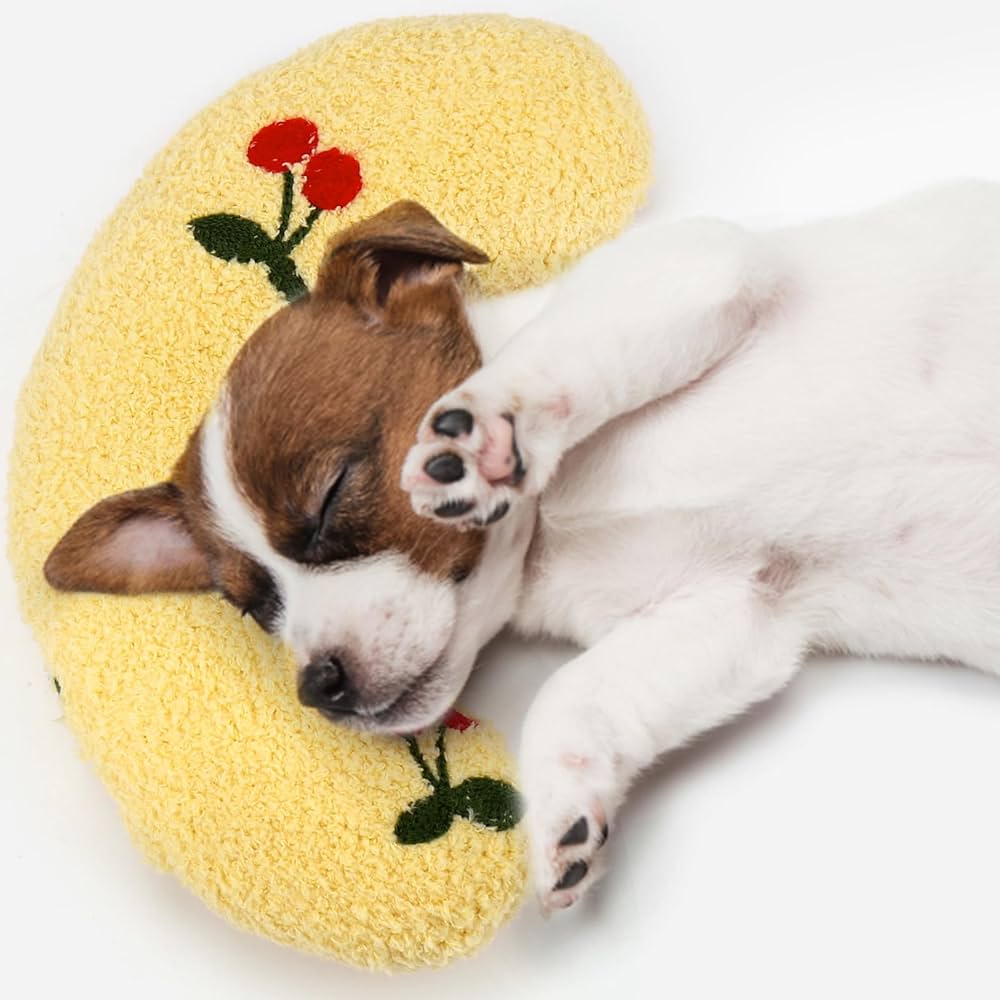 Puppy sleeping on a yellow dog calming pillow made of soft fabric