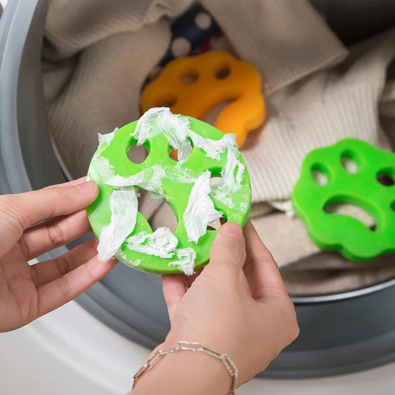Reusable green pet hair remover holding collected dog and cat hair after washing cycle inside washing machine