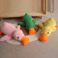 Three plush squeaky duck toys in green, pink, and yellow