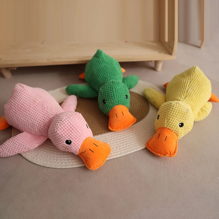Three plush squeaky duck toys in green, pink, and yellow
