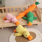 Plush squeaky duck pet toys in green, pink, and yellow colors displayed in a cozy indoor setting.
