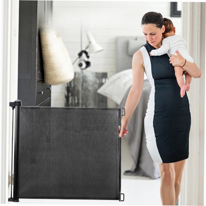 Retractable dog gate used as a child safety barrier in hallway