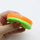 Green and orange sticky pet hair remover with reusable surface