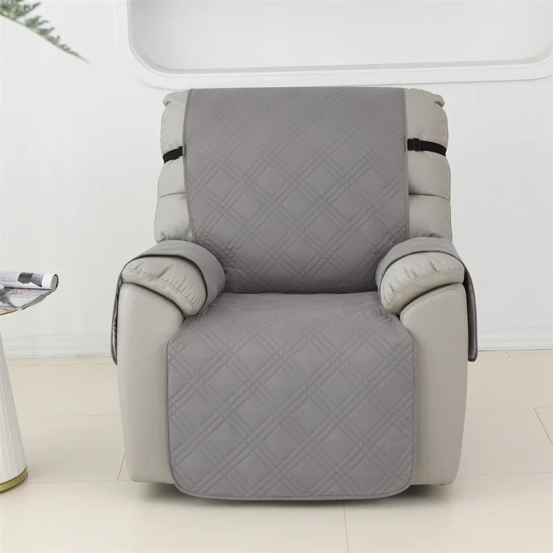Waterproof quilted recliner slipcover covering back, seat, front panel, and armrests with secure straps