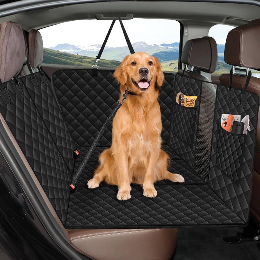 Waterproof dog car seat cover installed on back seat with safety leash attached, providing stable and protected space for a dog during travel.